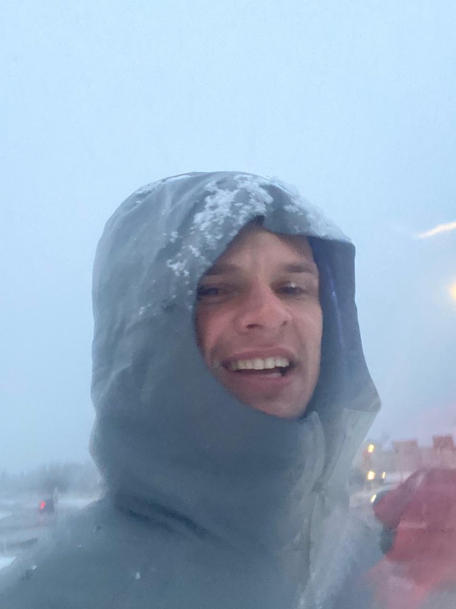 Renier Louwrens smiling in a snowstorm