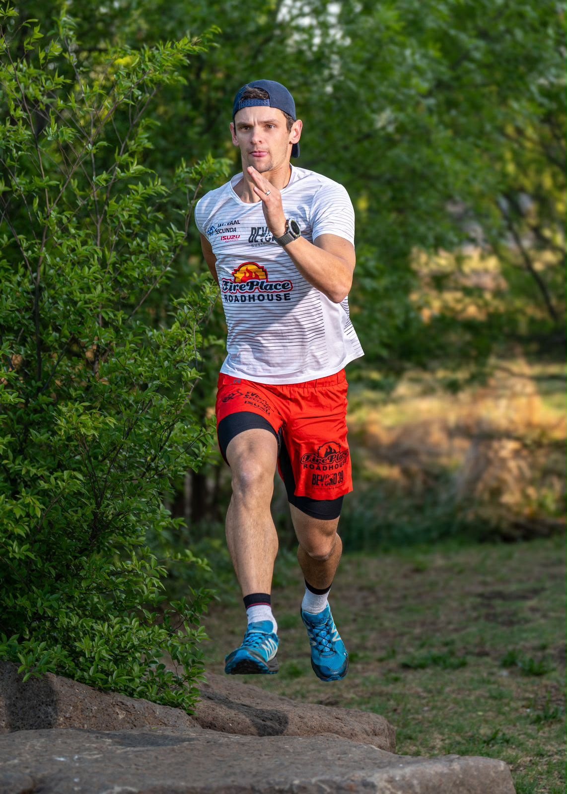 Renier Louwrens running over rocks